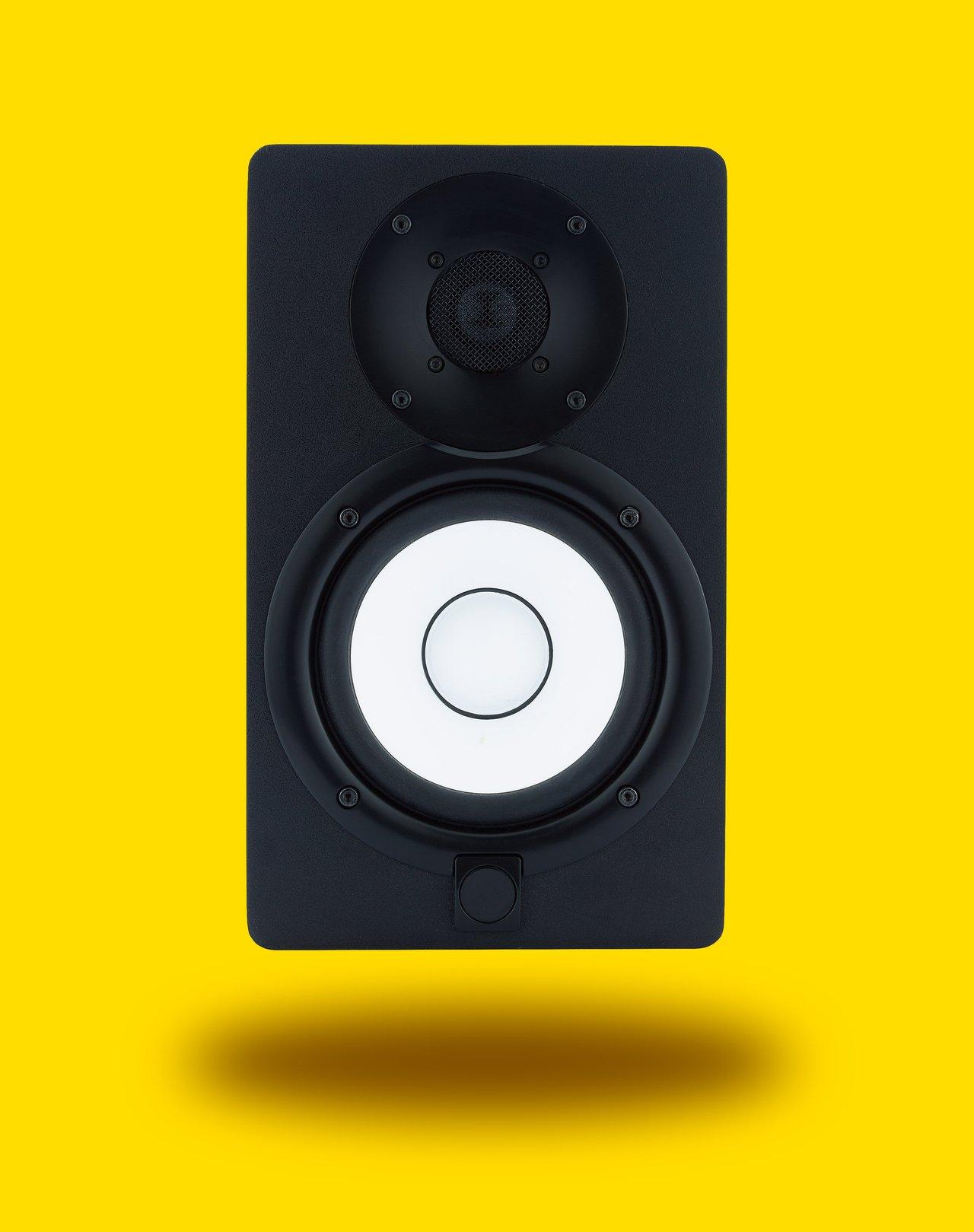 Paired active studio monitors with XLR and TRS connections for precise sound in home recording setups.